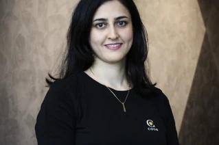 Portrait of woman in black working uniform.