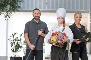 Service employees posing in their work-uniforms.