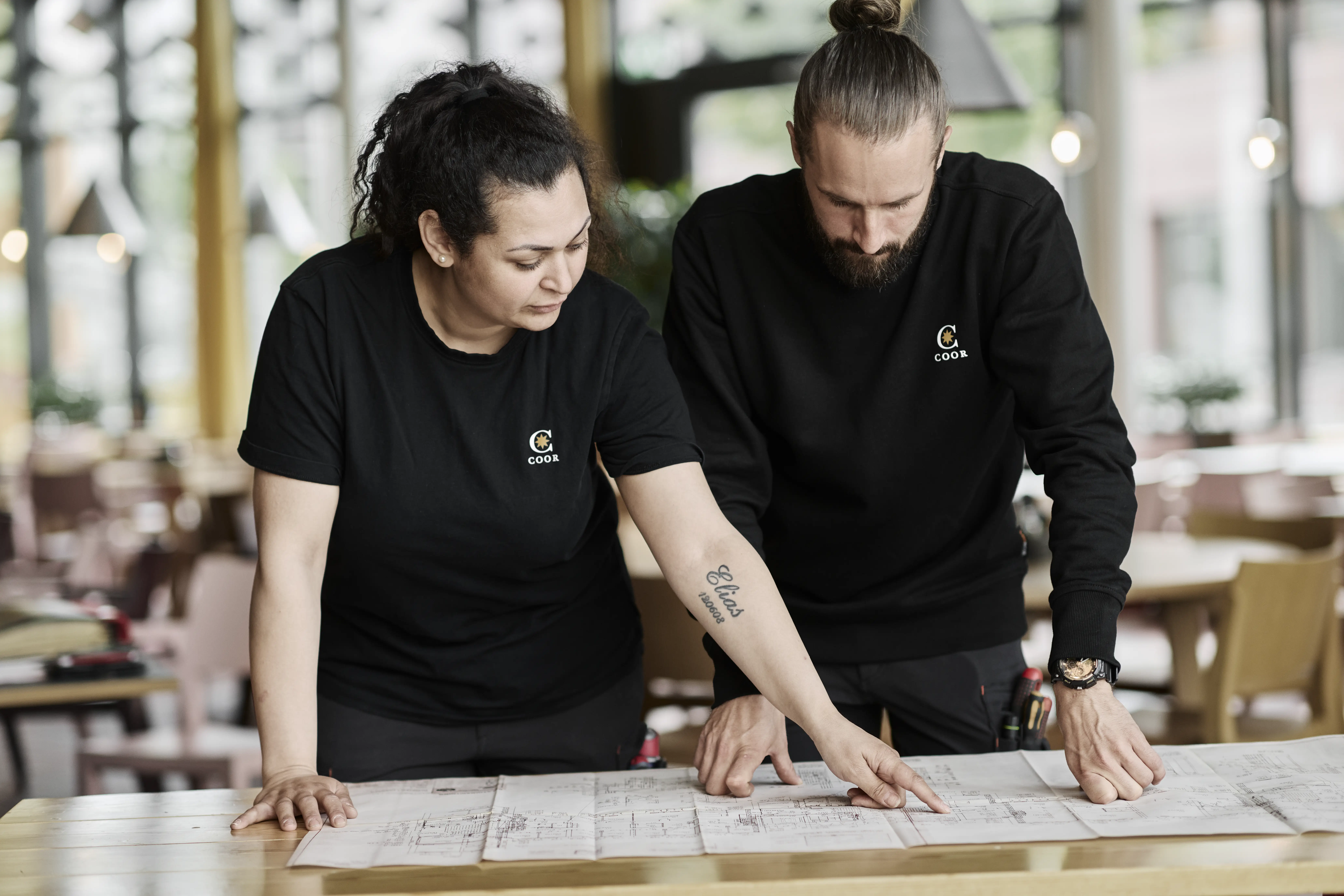 Two property technicians studying a drawing of building